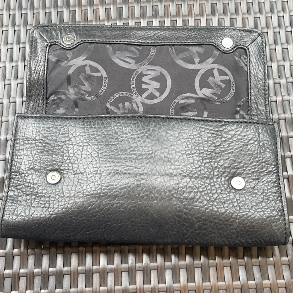 Michael kors Pebbled leather MK clutch with gun metal zipper.